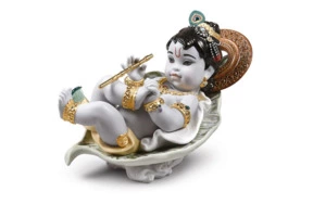 Фигурка Lladro Кришны на листе 13х21 см, фарфор